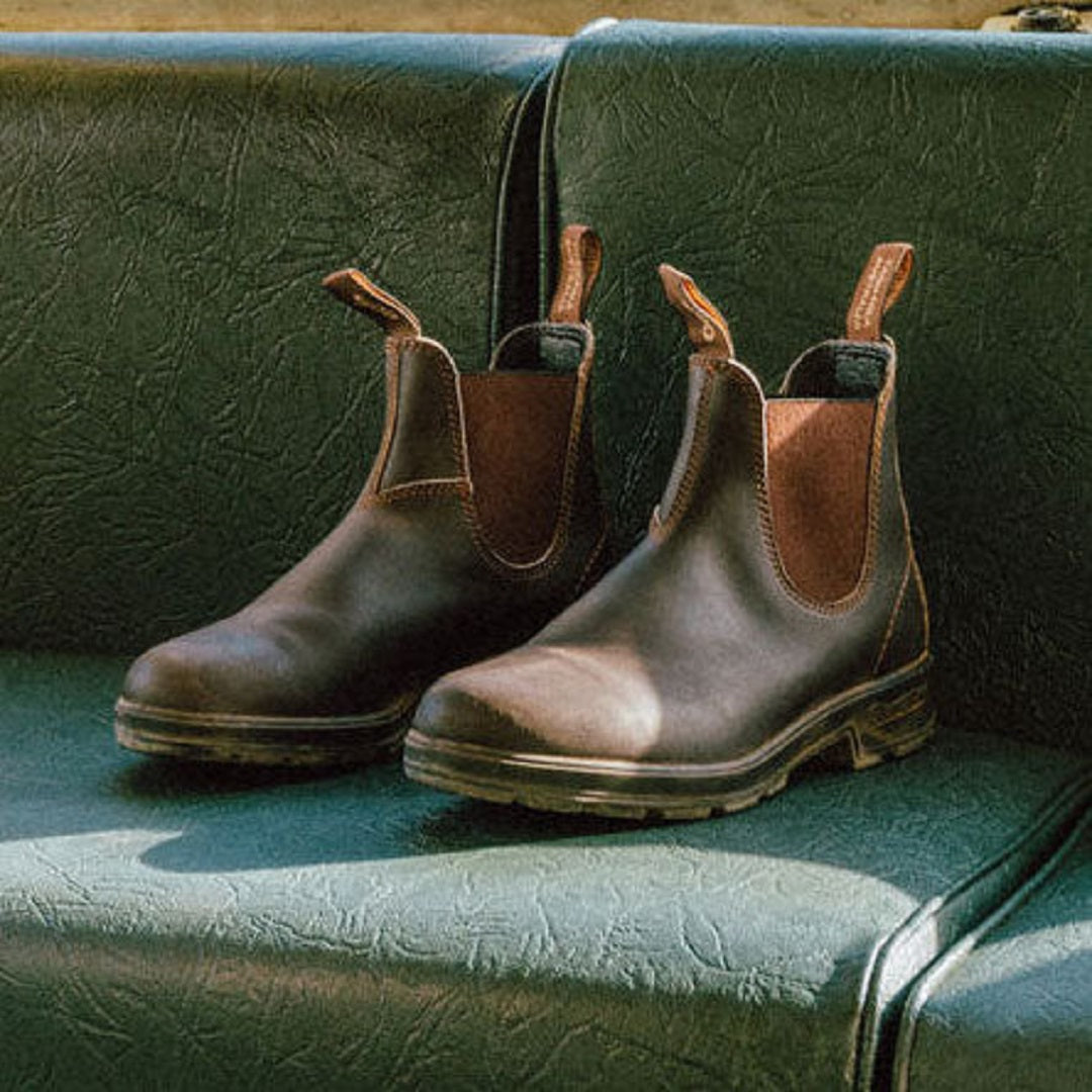 Blundstone boots on green leather couch