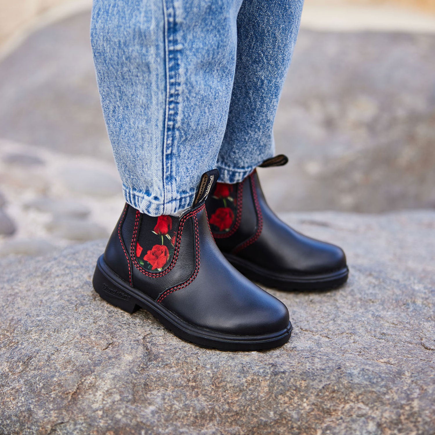 Blundstone 2252 Kids Black with Red Rose Elastic standing on a rock